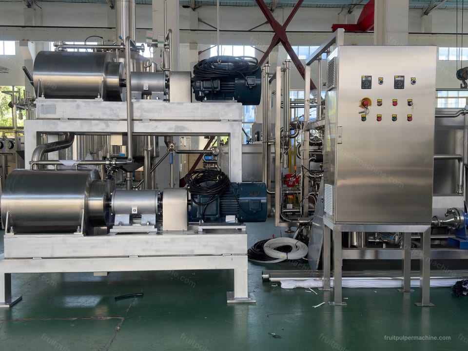 Side view of a two-stage fruit pulper assembly with separate drive units and stainless housings